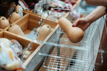 Putting butternut squash into shopping basket