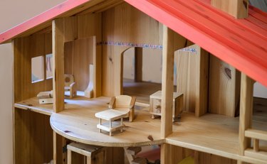 Close-up of a wooden dollhouse with doll furniture and accessories for the doll house