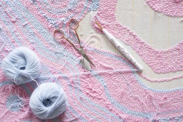 Making a wall rug by hand.  Art of manual tufting.