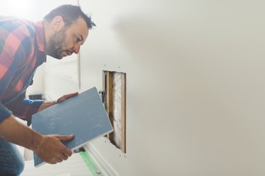 Man repairing the drywall
