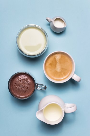 Coffee, cocoa and matcha with white creamers of milk