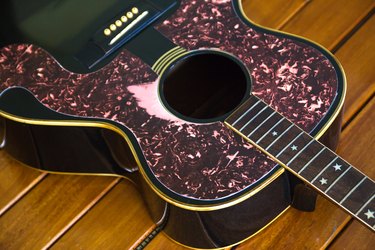 Vintage top guitar on old wood surface.