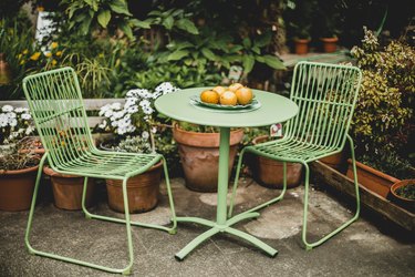 green garden furniture in a small garden.