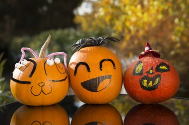 Three Halloween pumpkins decorated by children