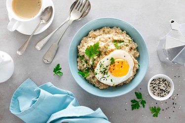 Savory oatmeal topped with fried eggs for breakfast