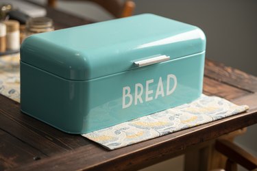 Bread box on kitchen table.