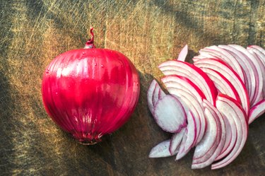 Red onion and slices on cutting board