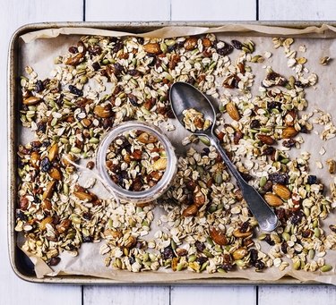 Tray of granola on white wood background