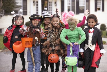 Children (4-7) dressed up for Halloween, group portrait