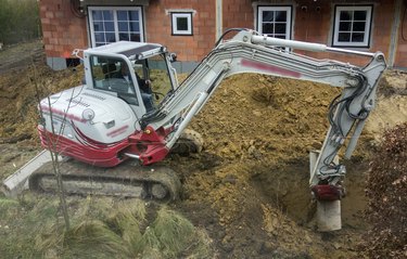 Aerial View Of Backhoe Digger At Building Site