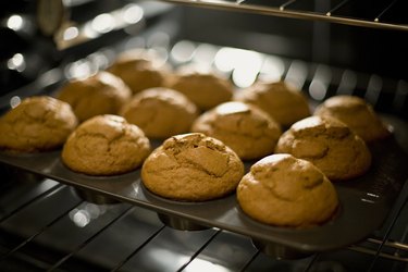 Pumpkin muffins shown in the pan, in the oven