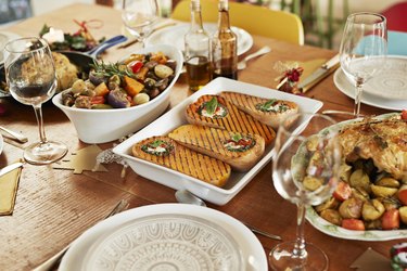 Meal with wine served on dining table at home