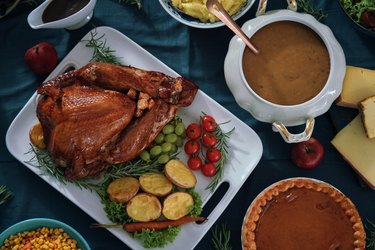 Stuffed turkey for Thanksgiving with pumpkin pie, gravy and other dishes