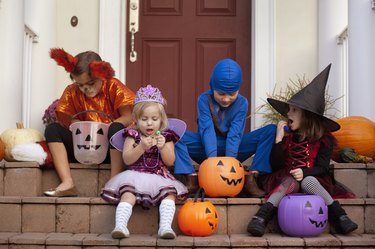 Children enjoying treats on steps