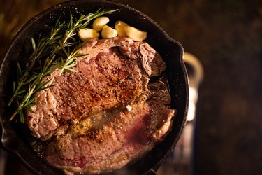 Steak with rosemary and garlic in a cast-iron skillet