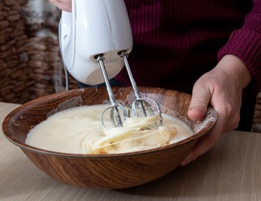 Mix the dough in a bowl with an electric mixer. Selective focus.