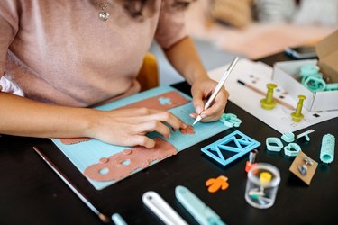 Woman designing jewelry in her atelier