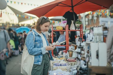 Young girl exploring organic body care goods at an open-air market with zero waste concept