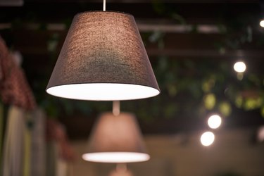 Pendant lamps over tables in restaurant. Modern pendant muted lighting with lampshades