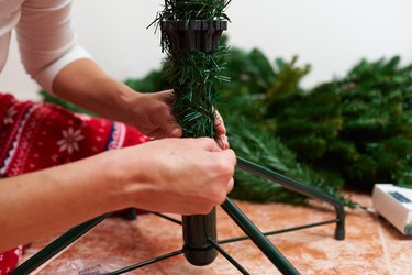 Close up shoot of an unrecognizable woman assembling christmas tree