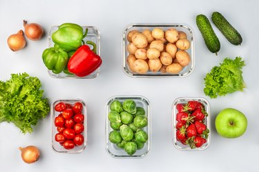 Glass boxes with fresh raw vegetables.  Vegetables and fruits in glass containers. Food storage concept