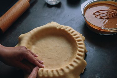 Preparing Pumpkin Pie for the Holidays in Domestic Kitchen