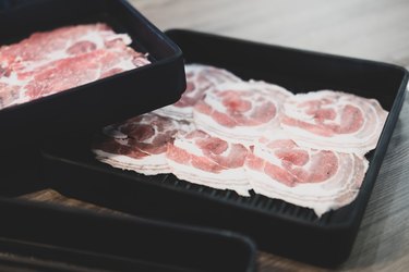 Premium sliced pork on black tray