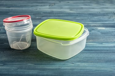 Plastic food containers on a wooden table