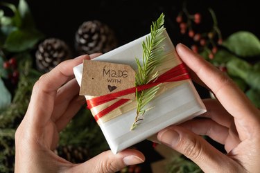 Close-up of gift with label "made with love" held by hands