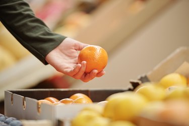 Choosing tangerine at market