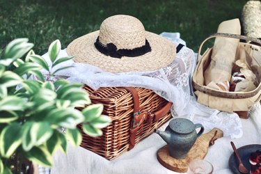 Picnic with bread and tea in summer garden