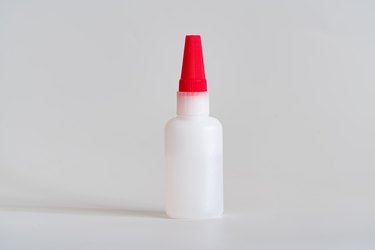 A bottle of glue. Glue plastic bottle