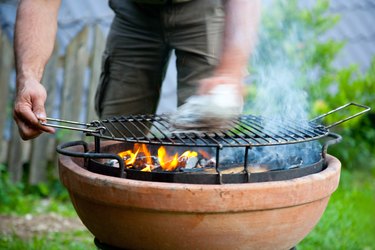 Adult Man Cleaning Barbecue Grill