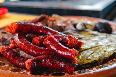 Traditional dish filled with sausage, a nopal and meat on a spit.