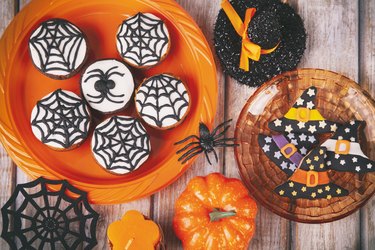 Halloween party with homemade gingerbread cookies on white rustic wooden table