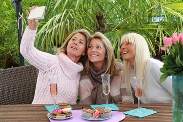 Three mature woman taking selfie