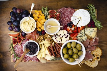 Grazing board, including a variety of meats, fruit and cheeses