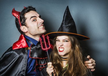 Halloween devil and witch pulling faces.