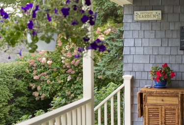 Front Porch of home close up with Hanging Baskets in summer