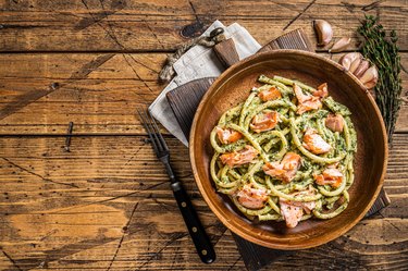 Italian traditional Pasta al Salmone,  Bucatini pasta with Smoked Salmon. Wooden background. Top view. Copy space