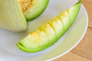 a piece of fresh green melon in dish
