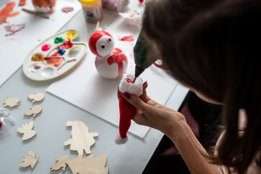 Top view of a woman making Christmas holiday decorations