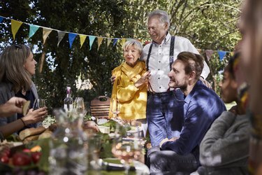 Happy senior couple hosting a garden party