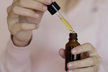 Woman Hands Holding Pipette Of Essential Oil