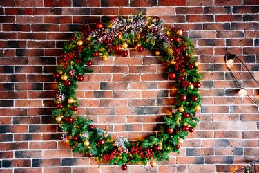 beautiful big New Year's wreath on a brick wall.