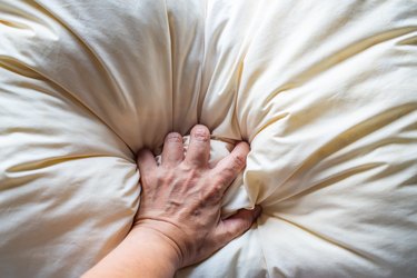 High Angle View Of Person Lying On Bed