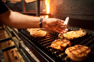 Measuring temperature of steak on grill