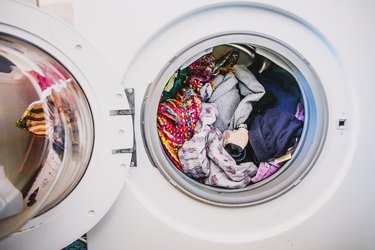 Washing machine full of colorful clothes
