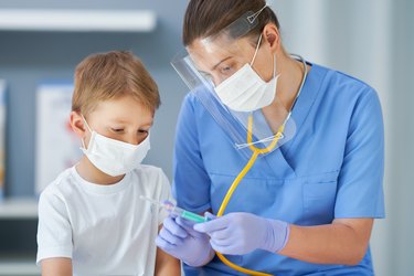 Portrait of adorable little boy being vaccinate at doctor's office