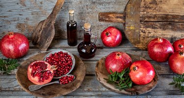 Pomegranate syrup named nar ekşisi or nar eksisi with pomegranates on the serving platter.